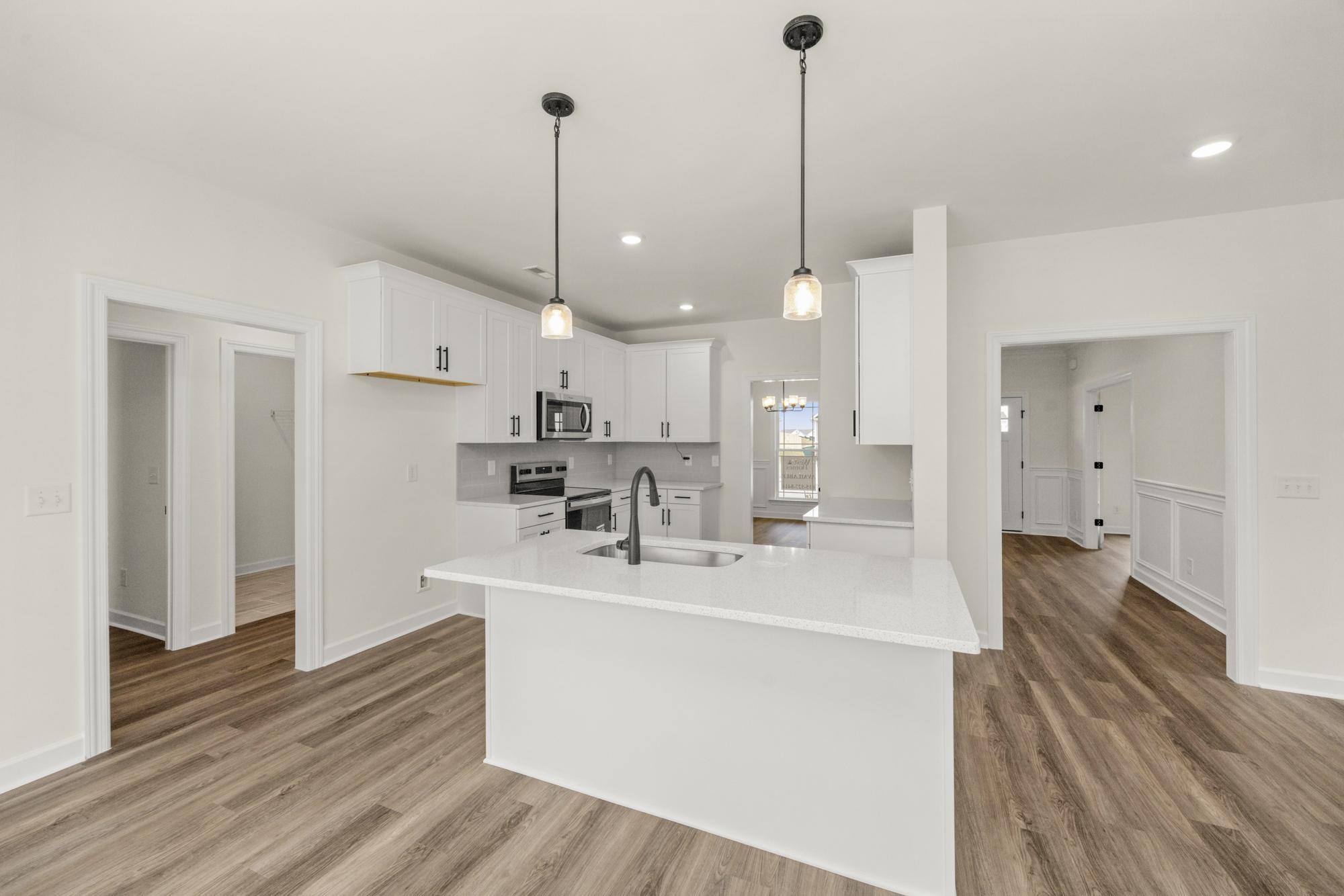 4002 Rampart Way Spring Hill Spring Hill, TN 37174 - Photo 11 of 42 a room with stainless steel appliances kitchen island granite countertop a sink a refrigerator and a wooden floor