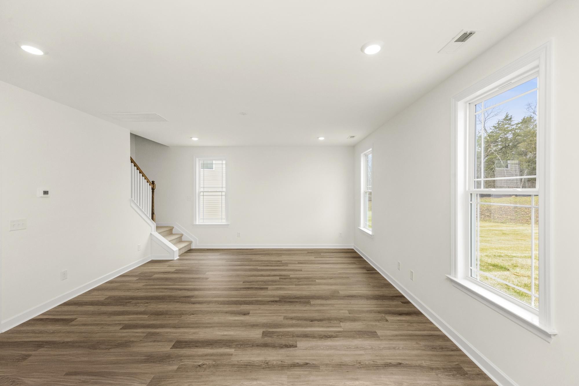 4002 Rampart Way Spring Hill Spring Hill, TN 37174 - Photo 15 of 42 a view of an empty room with wooden floor and a window