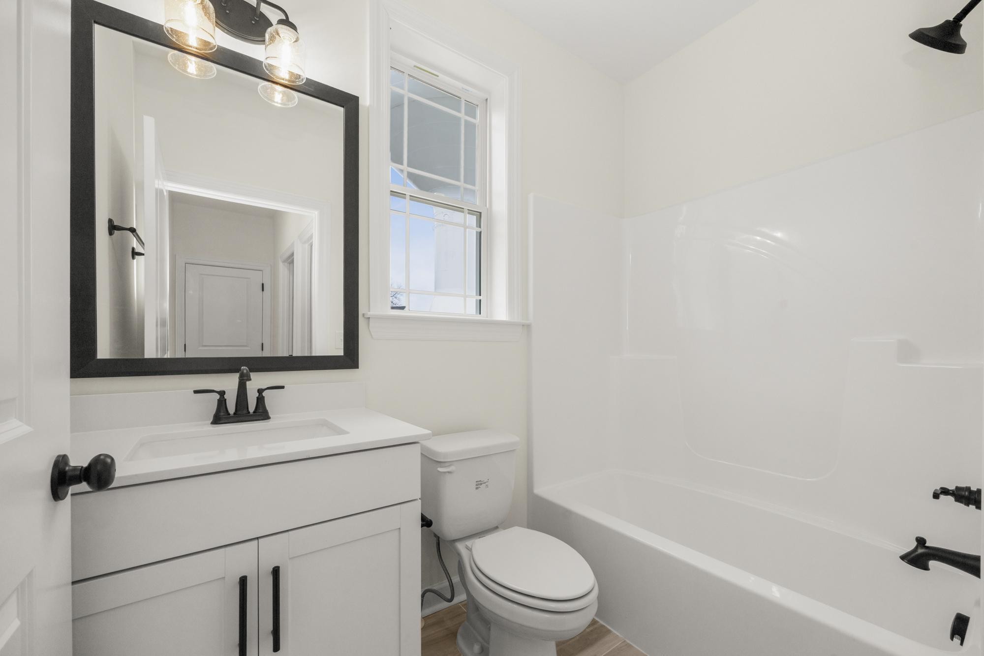 4002 Rampart Way Spring Hill Spring Hill, TN 37174 - Photo 18 of 42 a bathroom with a toilet sink and mirror
