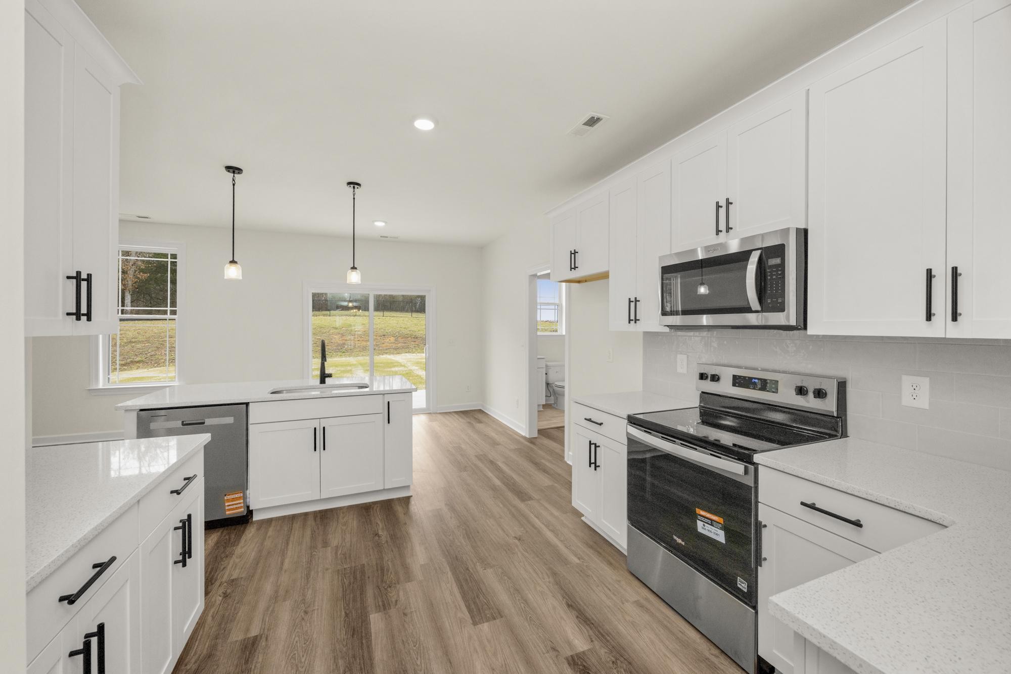 4002 Rampart Way Spring Hill Spring Hill, TN 37174 - Photo 8 of 42 a kitchen with stainless steel appliances granite countertop a stove a sink and a microwave
