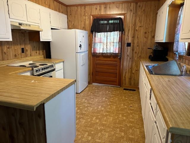 420 G B Plunk Road Selmer, TN 38375 - Photo 2 of 26 Kitchen with white cabinetry, kitchen peninsula, light parquet floors, gas range, and white refrigerator