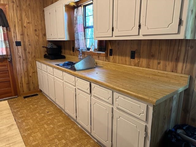 420 G B Plunk Road Selmer, TN 38375 - Photo 3 of 26 Kitchen featuring sink, light parquet flooring, and white cabinets