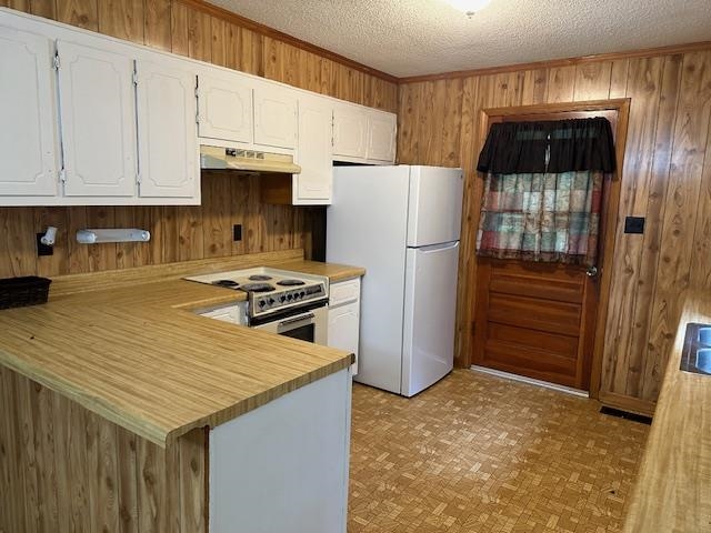 420 G B Plunk Road Selmer, TN 38375 - Photo 5 of 26 Kitchen with white fridge, kitchen peninsula, light parquet floors, stainless steel electric stove, and white cabinets