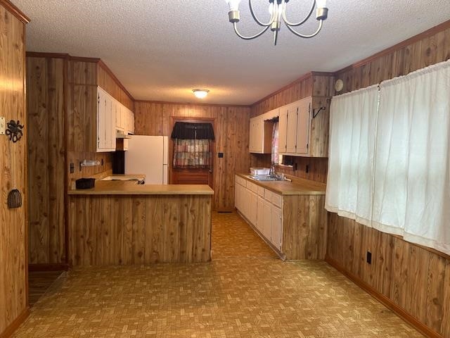 420 G B Plunk Road Selmer, TN 38375 - Photo 6 of 26 Kitchen featuring a textured ceiling, white refrigerator, light parquet flooring, and kitchen peninsula
