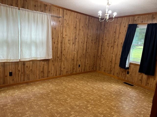 420 G B Plunk Road Selmer, TN 38375 - Photo 7 of 26 Spare room with parquet flooring, a chandelier, and a textured ceiling
