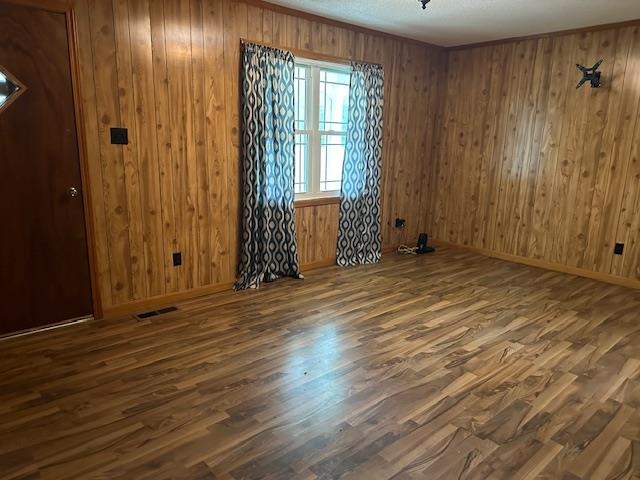 420 G B Plunk Road Selmer, TN 38375 - Photo 10 of 26 Empty room featuring wooden walls and dark wood-type flooring