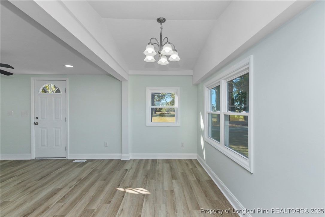 1340 George Perry Lee Road Dunn, NC 28334 - Photo 15 of 31 wooden floor in an empty room with a window