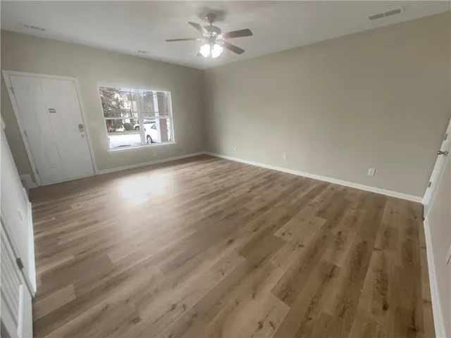 wooden floor in an empty room with a window