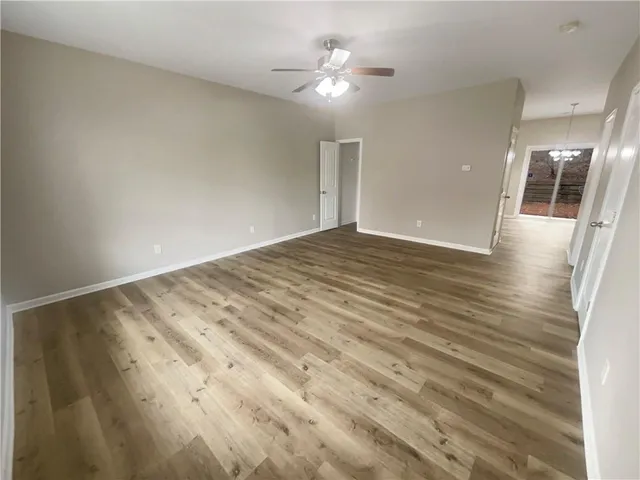 wooden floor in an empty room with a window