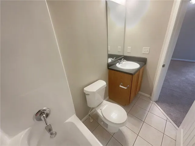 a bathroom with a sink toilet and a mirror