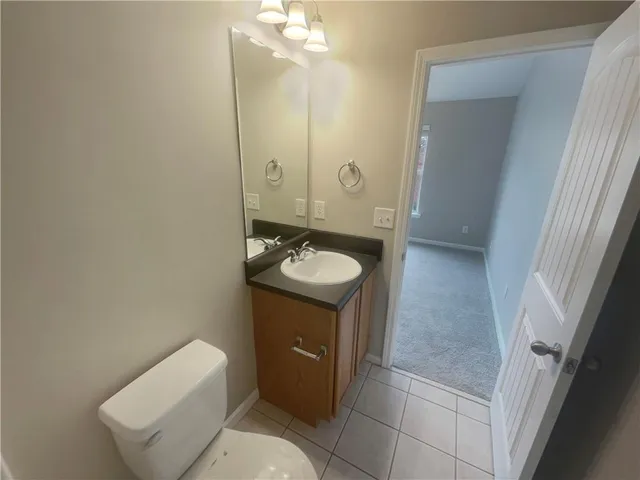 a bathroom with a sink toilet and mirror