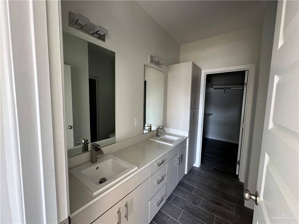 1805 Unity Drive Mercedes, TX 78570 - Photo 6 of 10 a bathroom with a tub a sink and a large mirror