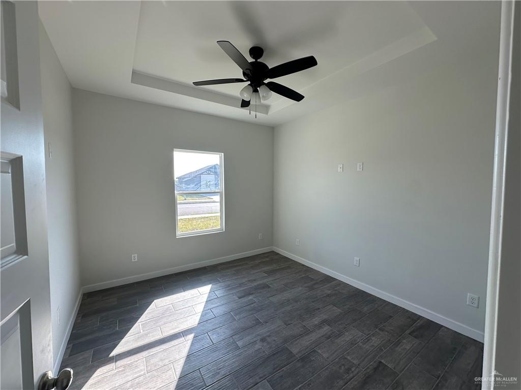 1805 Unity Drive Mercedes, TX 78570 - Photo 7 of 10 an empty room with a ceiling fan and window