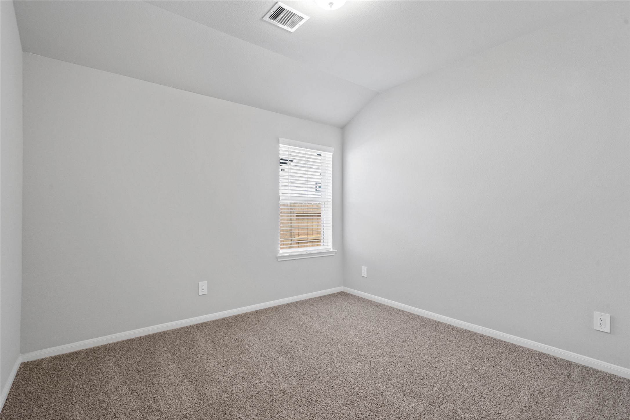 19645 Montgomery Rdg Way Montgomery, TX 77316 - Photo 10 of 41 Perfect for guests or a quiet home office, this room features soft plush carpeting, a window with fitted blinds, sloped ceiling, and ample sized closet space.