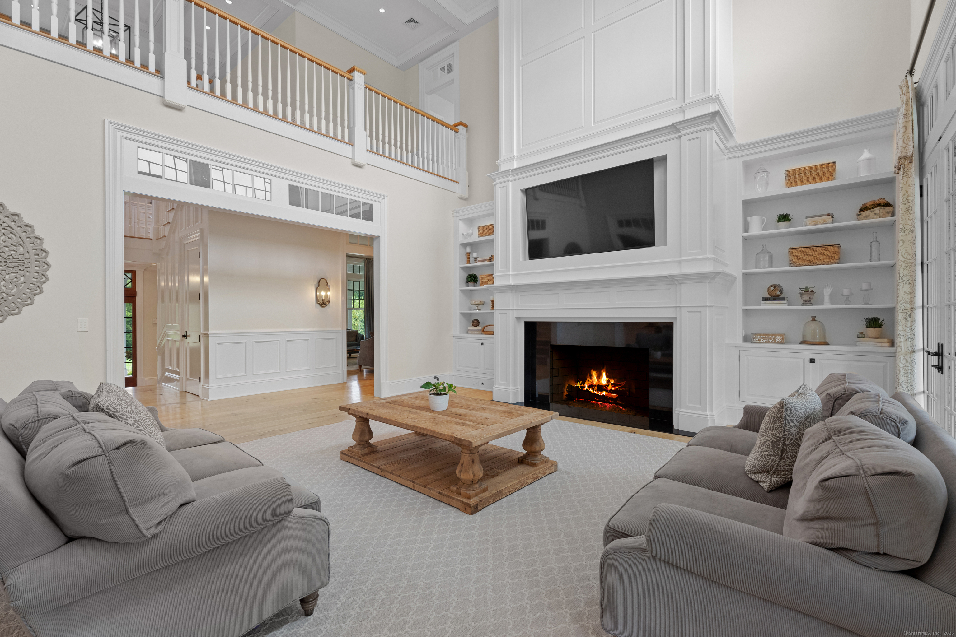 294 Maple Road Easton, CT 06612 - Photo 7 of 40 This two-story family room features a wood-burning fireplace flanked by custom built-ins.