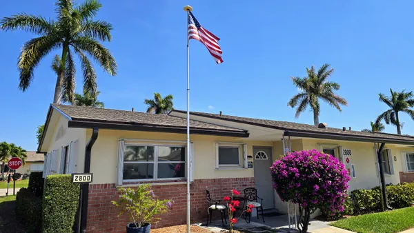 a front view of house with small garden
