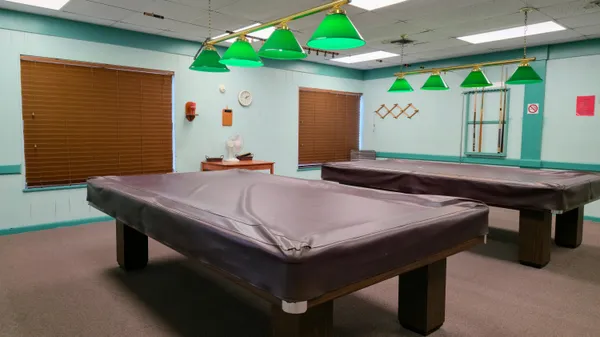 a very nice looking dining room with furniture a chandelier and wooden floor