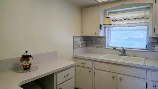 a kitchen with a cabinets and a stove top oven
