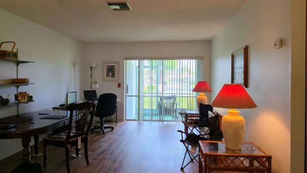 a view of a workspace with furniture and a livingroom