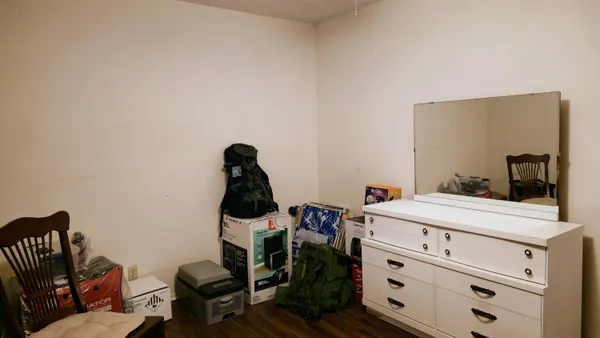 a view of a workspace with furniture and a window