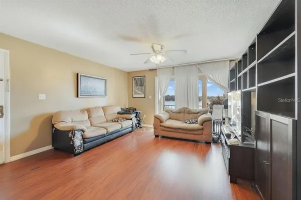 a living room with furniture and a wooden floor