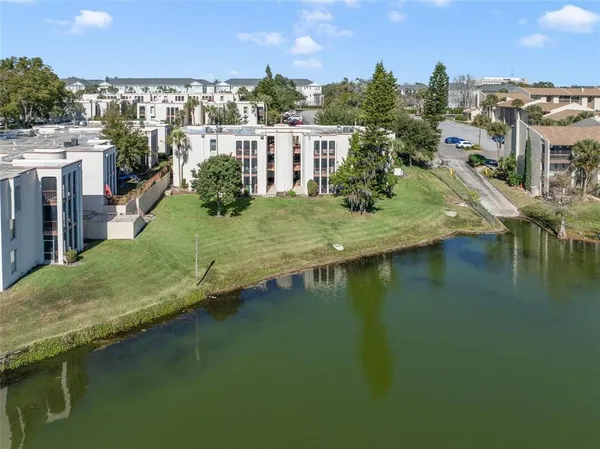 a view of residential houses with outdoor space and lake view