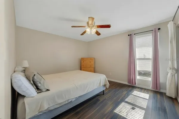 a front view of a house with a yard and large trees