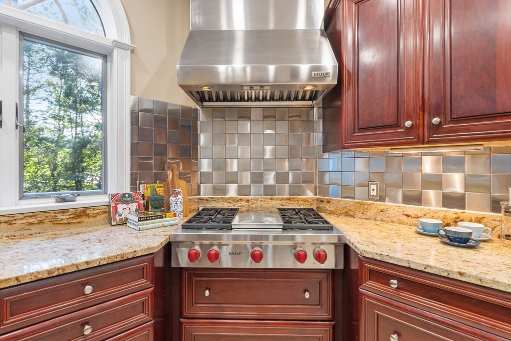117 Hidden Road Andover, MA 01810 - Photo 13 of 42 a stove top oven sitting inside of a kitchen