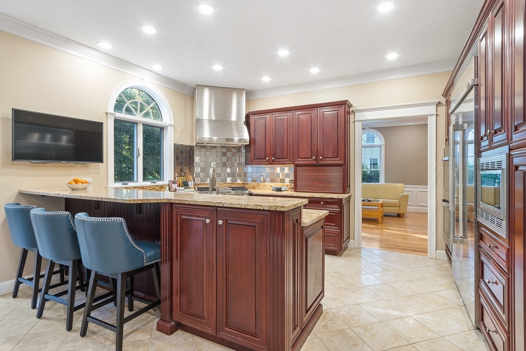 117 Hidden Road Andover, MA 01810 - Photo 15 of 42 a kitchen with a table and chairs in it