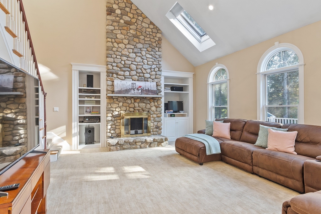 117 Hidden Road Andover, MA 01810 - Photo 17 of 42 a living room with furniture a fireplace and a large window