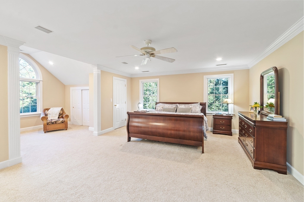 117 Hidden Road Andover, MA 01810 - Photo 23 of 42 a bedroom with furniture and a chandelier