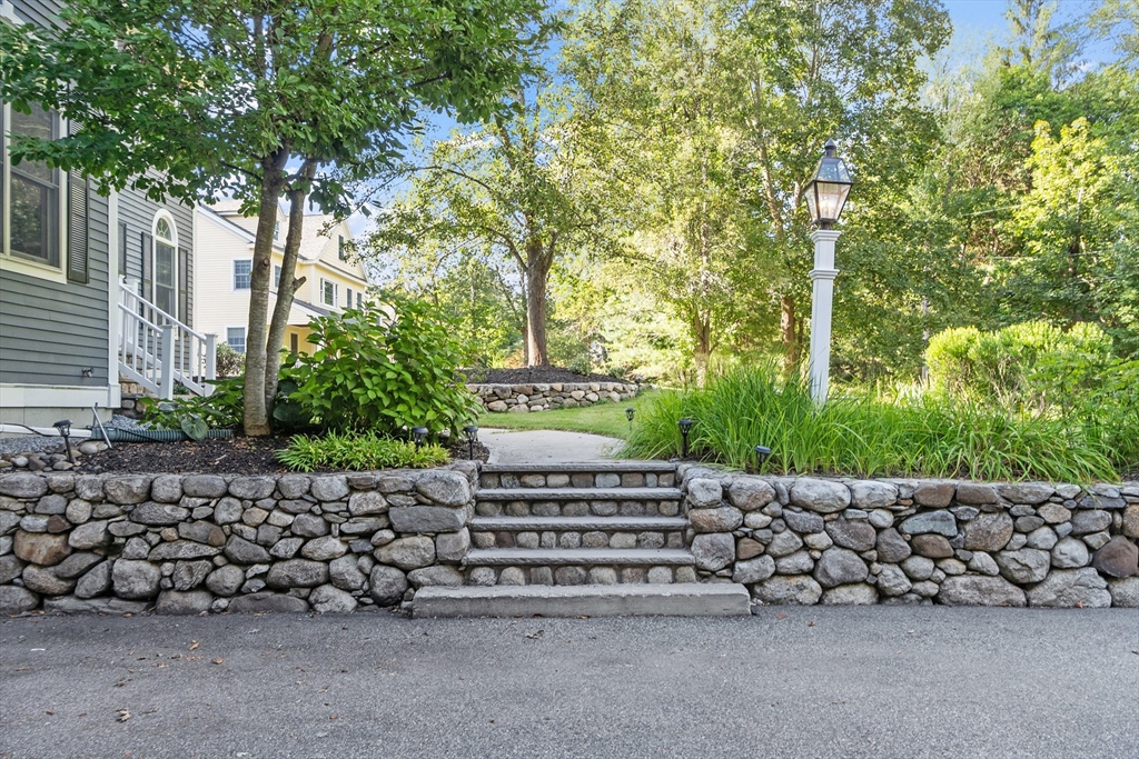 117 Hidden Road Andover, MA 01810 - Photo 4 of 42 a wooden bench sitting in front of a building