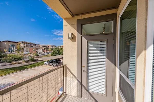 a view of a balcony with furniture and city view