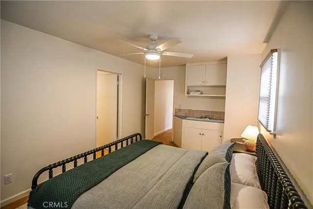 a kitchen with a refrigerator and white cabinets