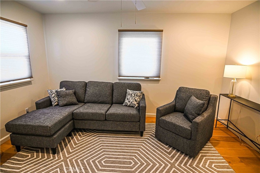 56 Gracia Avenue Cayucos, CA 93430 - Photo 5 of 12 a living room with a couch and a lamp with wooden floor