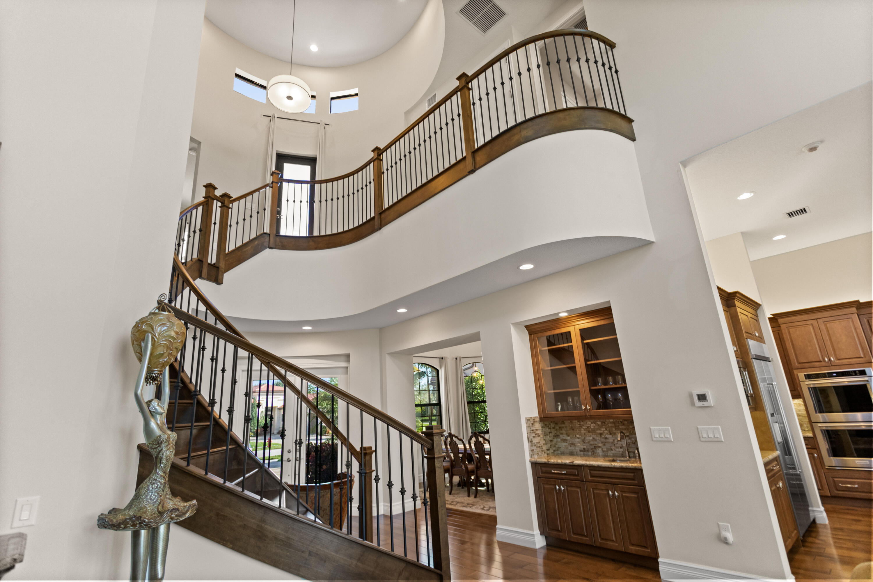 16743 Picardy Way Delray Beach, FL 33446 - Photo 22 of 79 a view of staircase with lots of frames on wall and windows