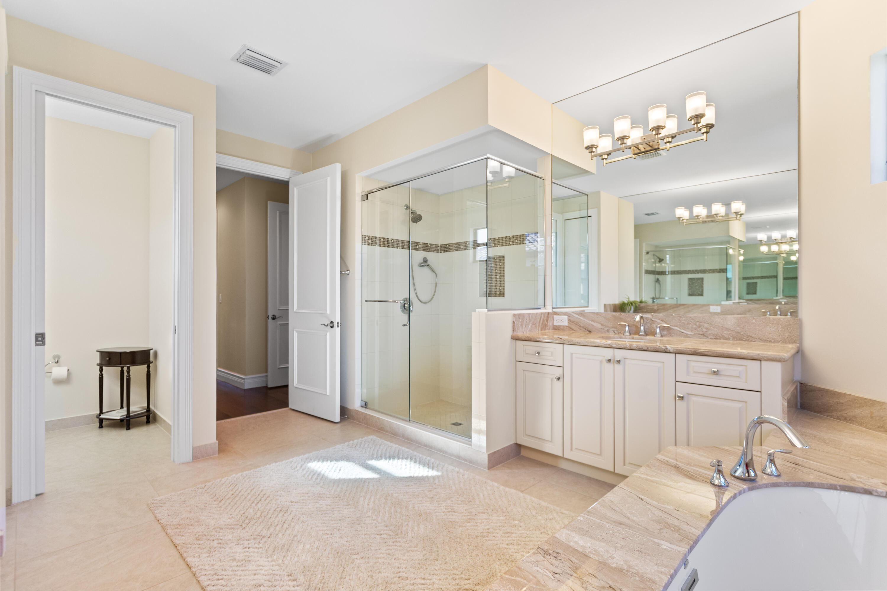 16743 Picardy Way Delray Beach, FL 33446 - Photo 29 of 79 a spacious bathroom with a granite countertop sink mirror and a shower