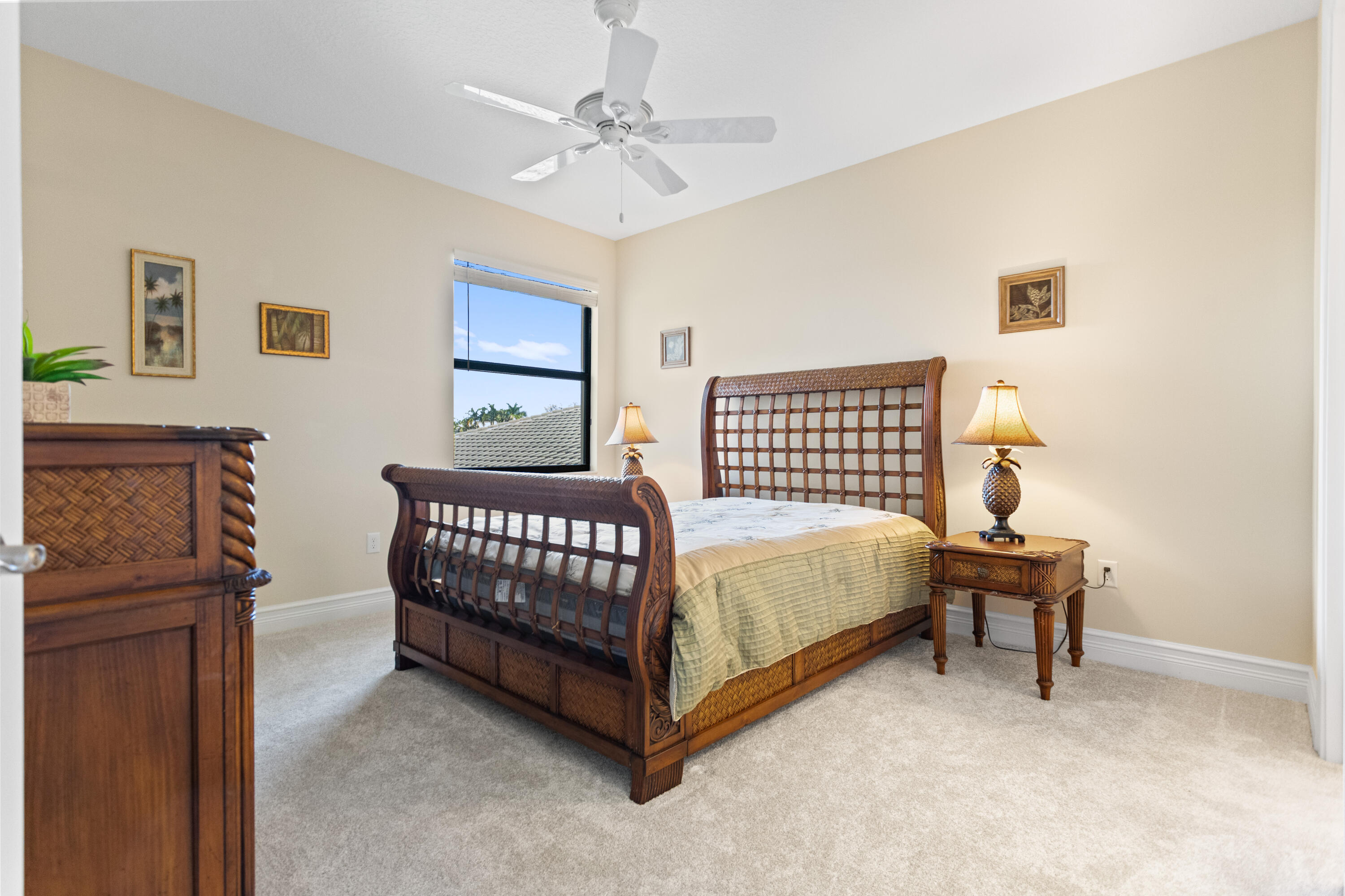 16743 Picardy Way Delray Beach, FL 33446 - Photo 39 of 79 a bedroom with a bed and a lamp with paintings on the wall