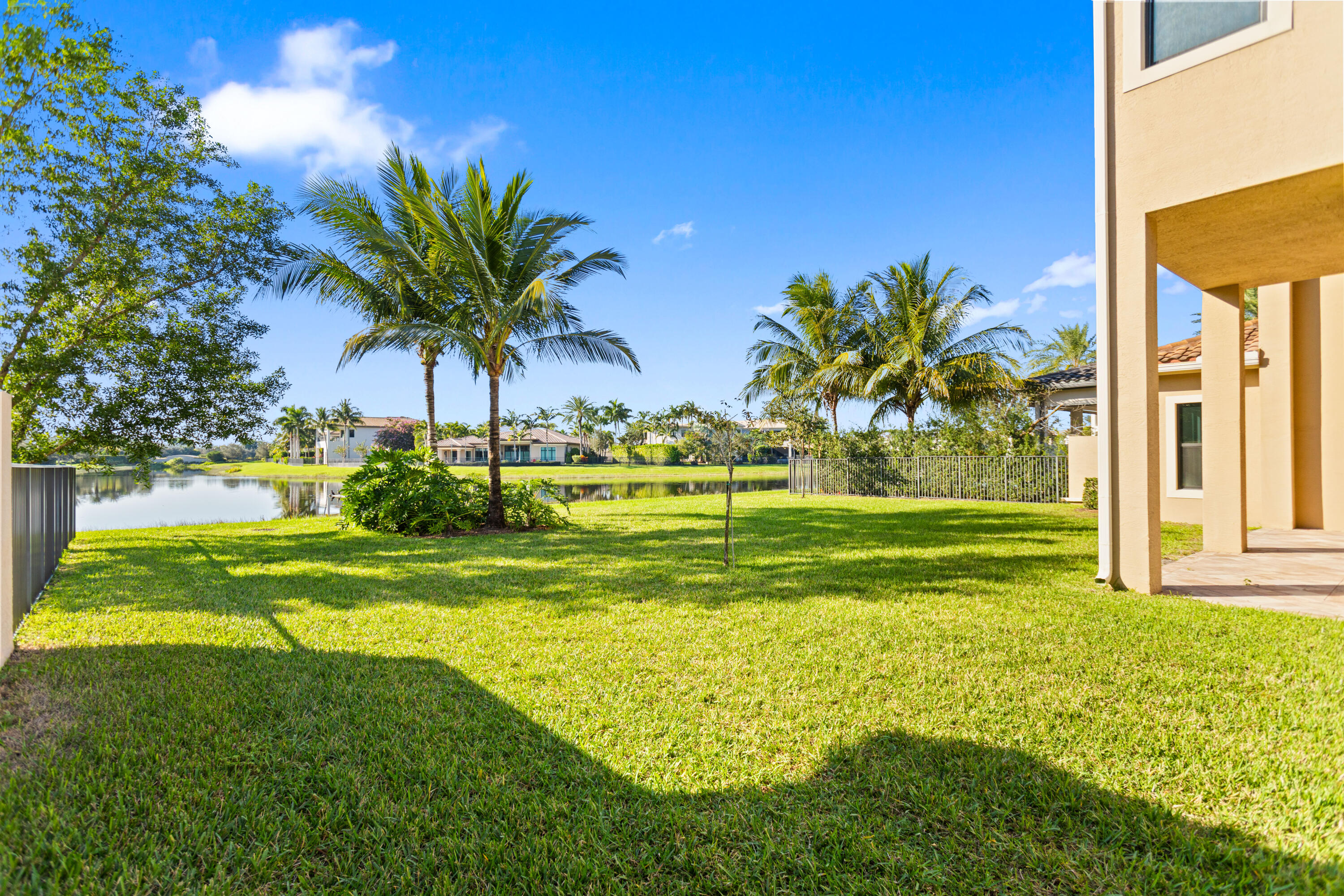 16743 Picardy Way Delray Beach, FL 33446 - Photo 48 of 79 a view of a swimming pool with a garden and palm trees