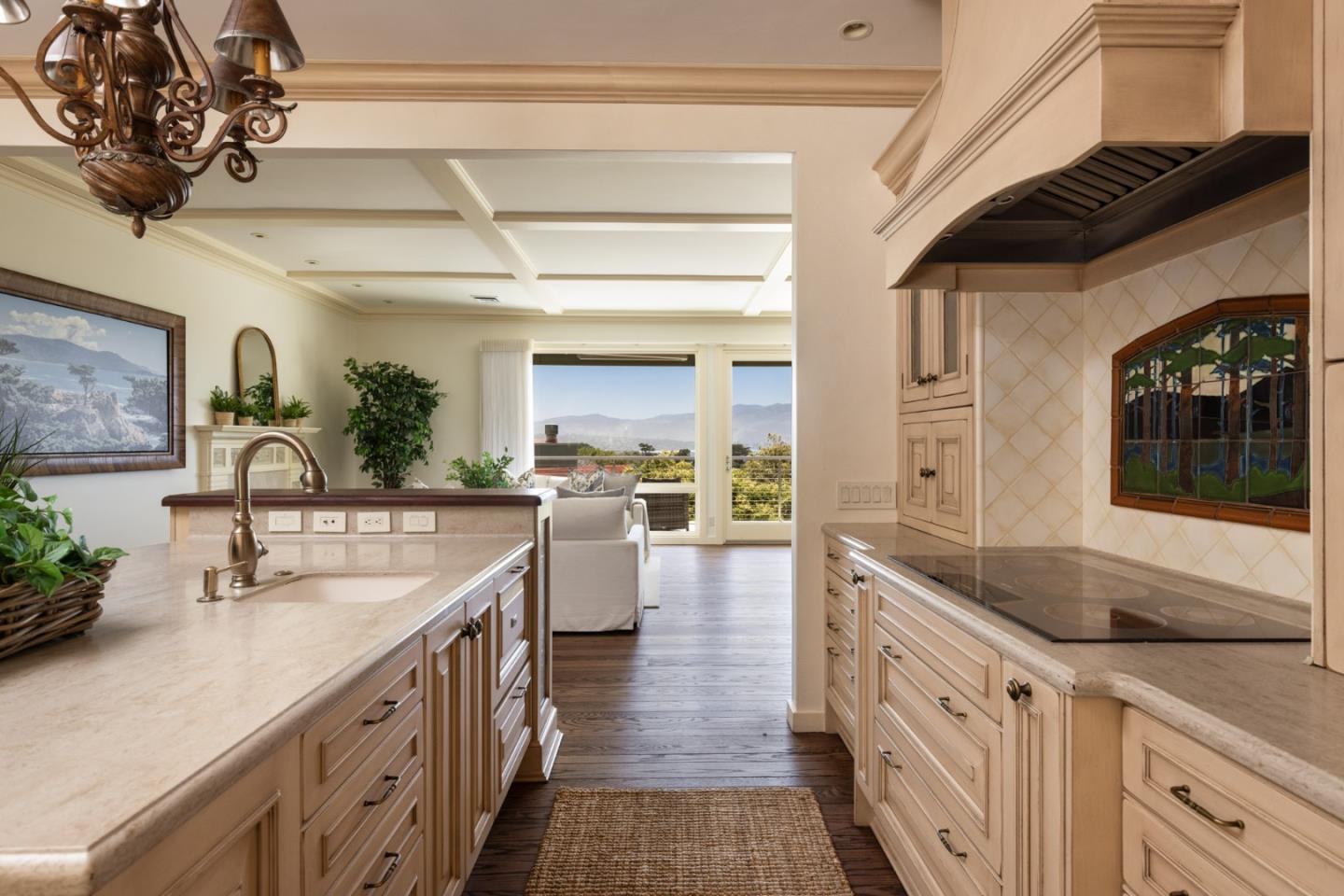 3307 17 Mile Drive, Unit 3 Pebble Beach, CA 93953 - Photo 13 of 42 a large white kitchen with a sink and dishwasher a stove with wooden floor