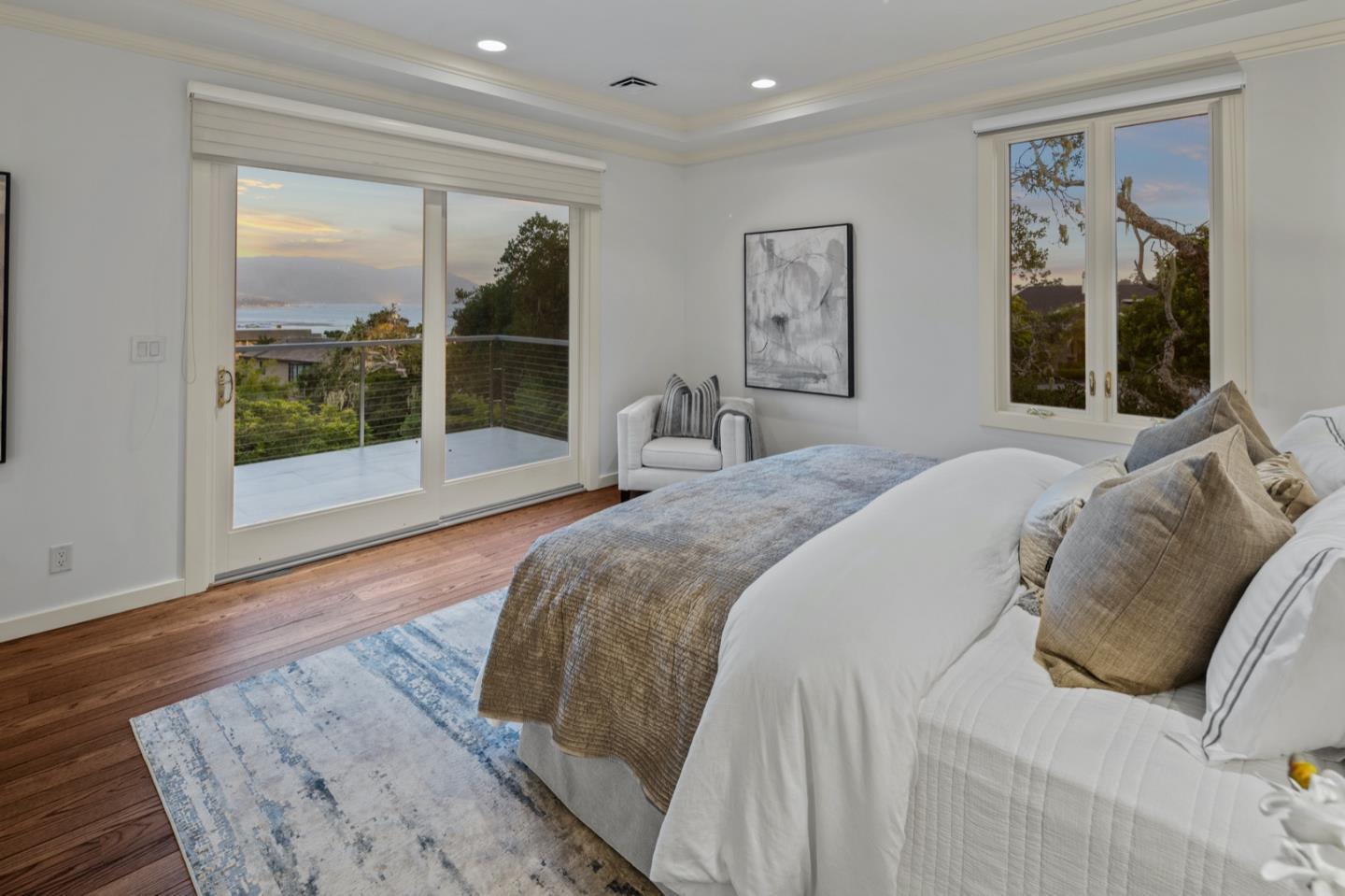3307 17 Mile Drive, Unit 3 Pebble Beach, CA 93953 - Photo 15 of 42 a bedroom with a large bed and a large window