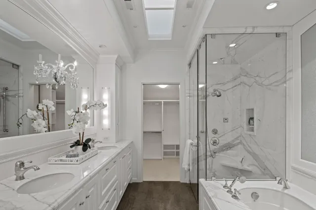 a spacious bathroom with a shower sink and mirror
