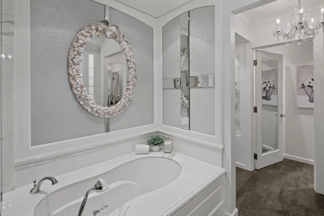 a bathroom with a bathtub a sink and a mirror