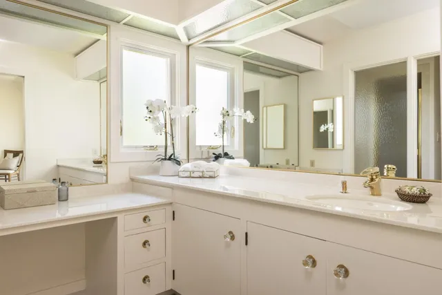 a bathroom with double vanity sinks and a mirror