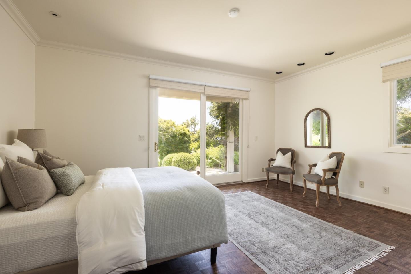 3307 17 Mile Drive, Unit 3 Pebble Beach, CA 93953 - Photo 22 of 42 a bedroom with a large bed and wooden floor