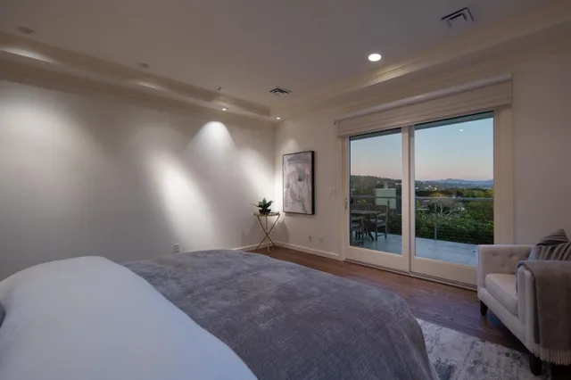 a bedroom with furniture and large windows
