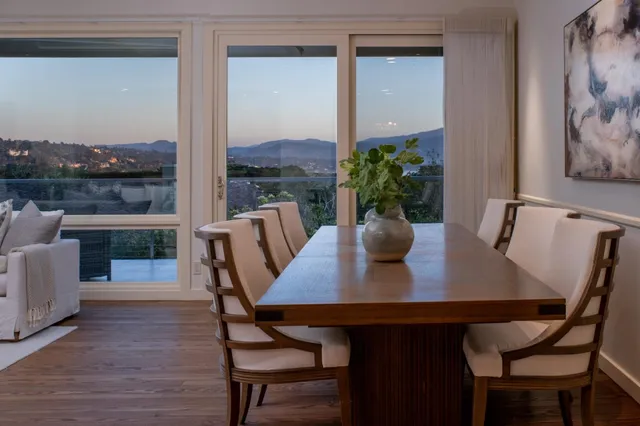 a view of a dining room with furniture window and wooden floor