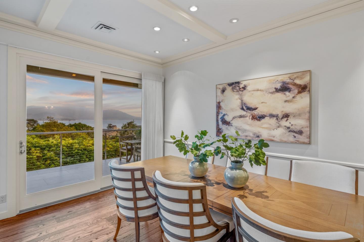 3307 17 Mile Drive, Unit 3 Pebble Beach, CA 93953 - Photo 8 of 42 a dining room with furniture potted plants and wooden floor