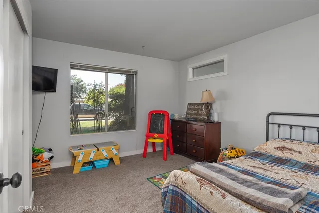 a bedroom with a bed and a tv