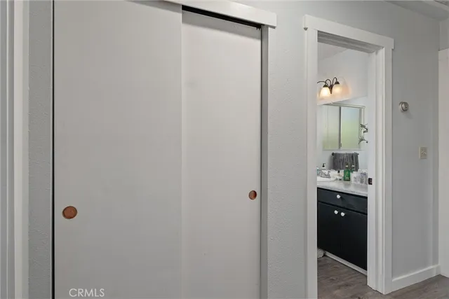 a view of a hallway with wooden shelves